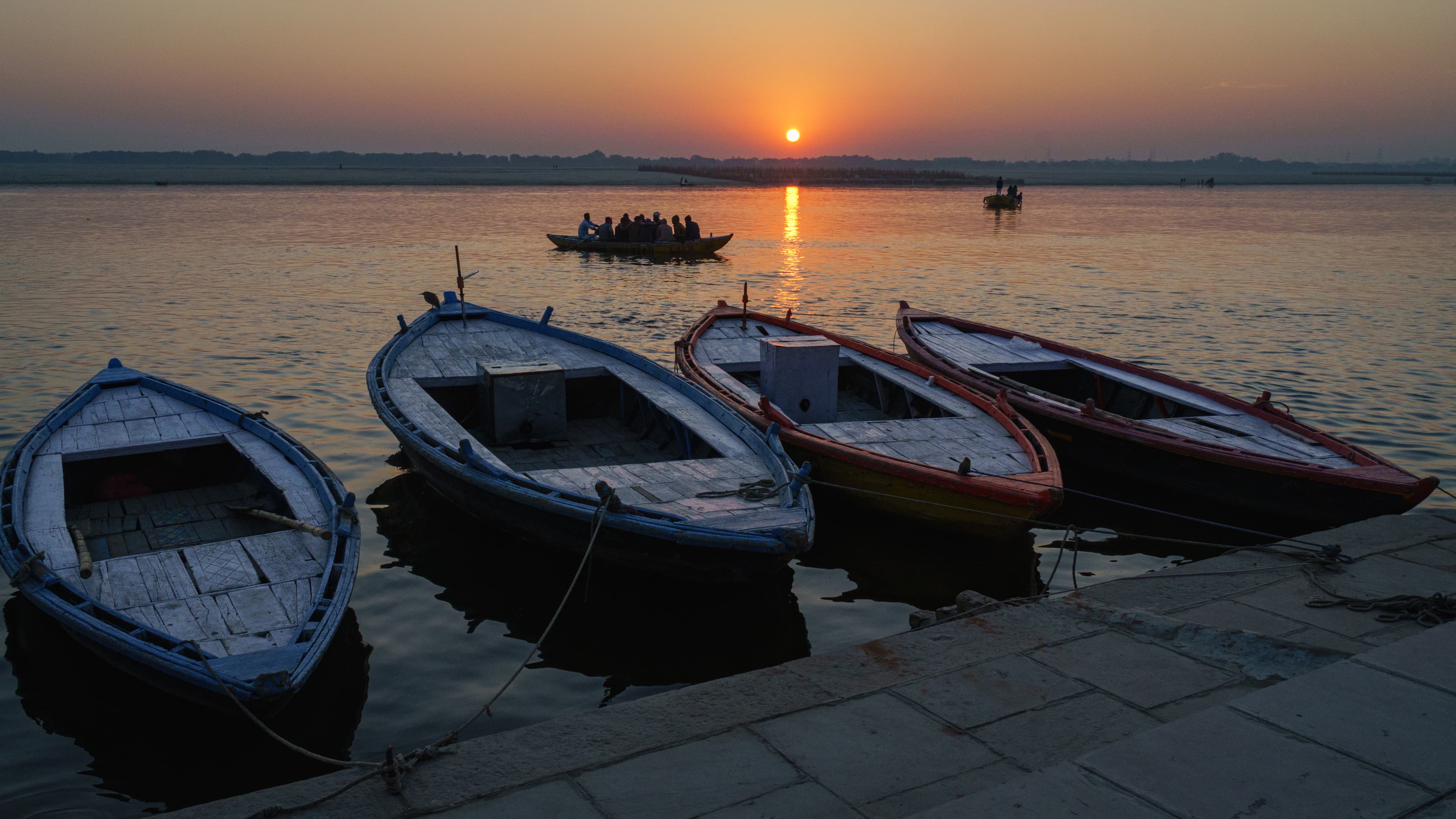 Traditional wooden riverboats at sunrise on the Ganges River, Varanasi